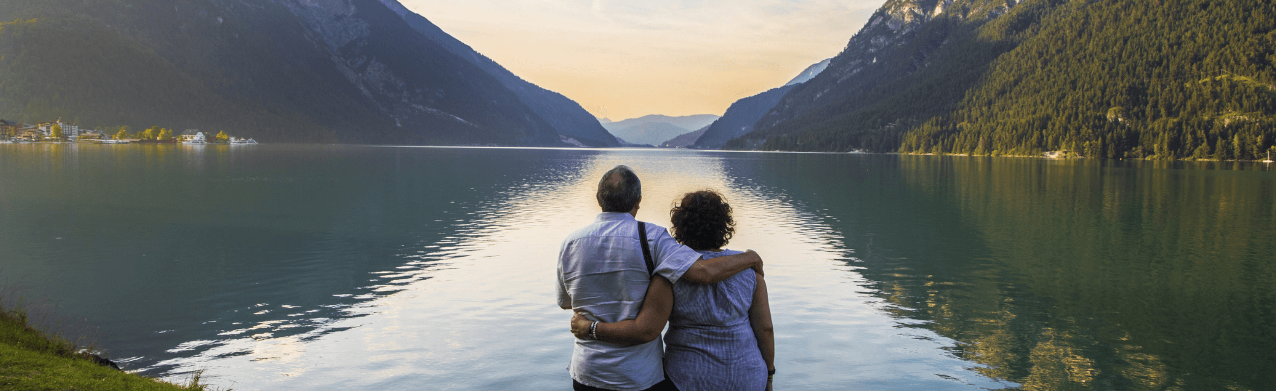 Photograph of a couple enjoying a sunset over a lake